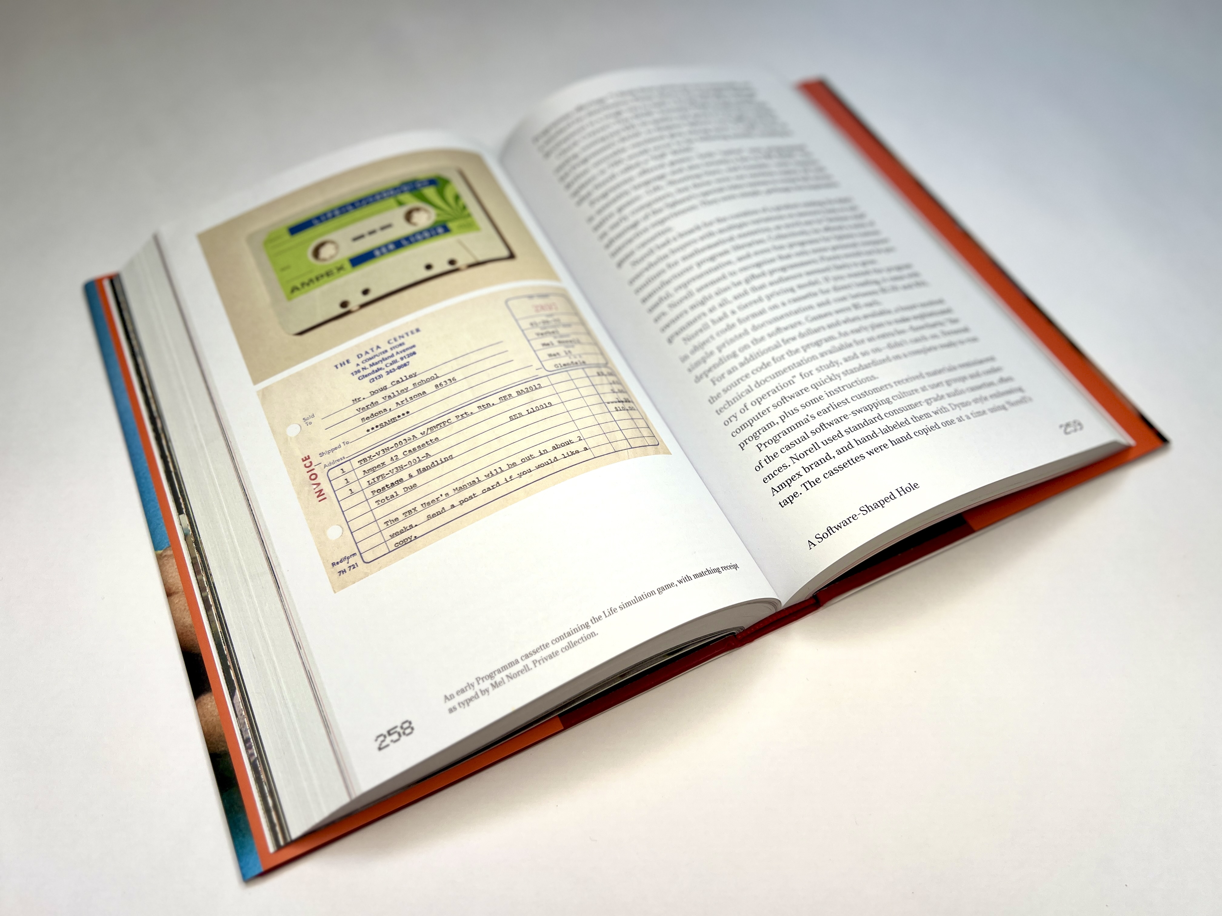 Interior spread showing an early Programma software cassette and a invoice, with body text.