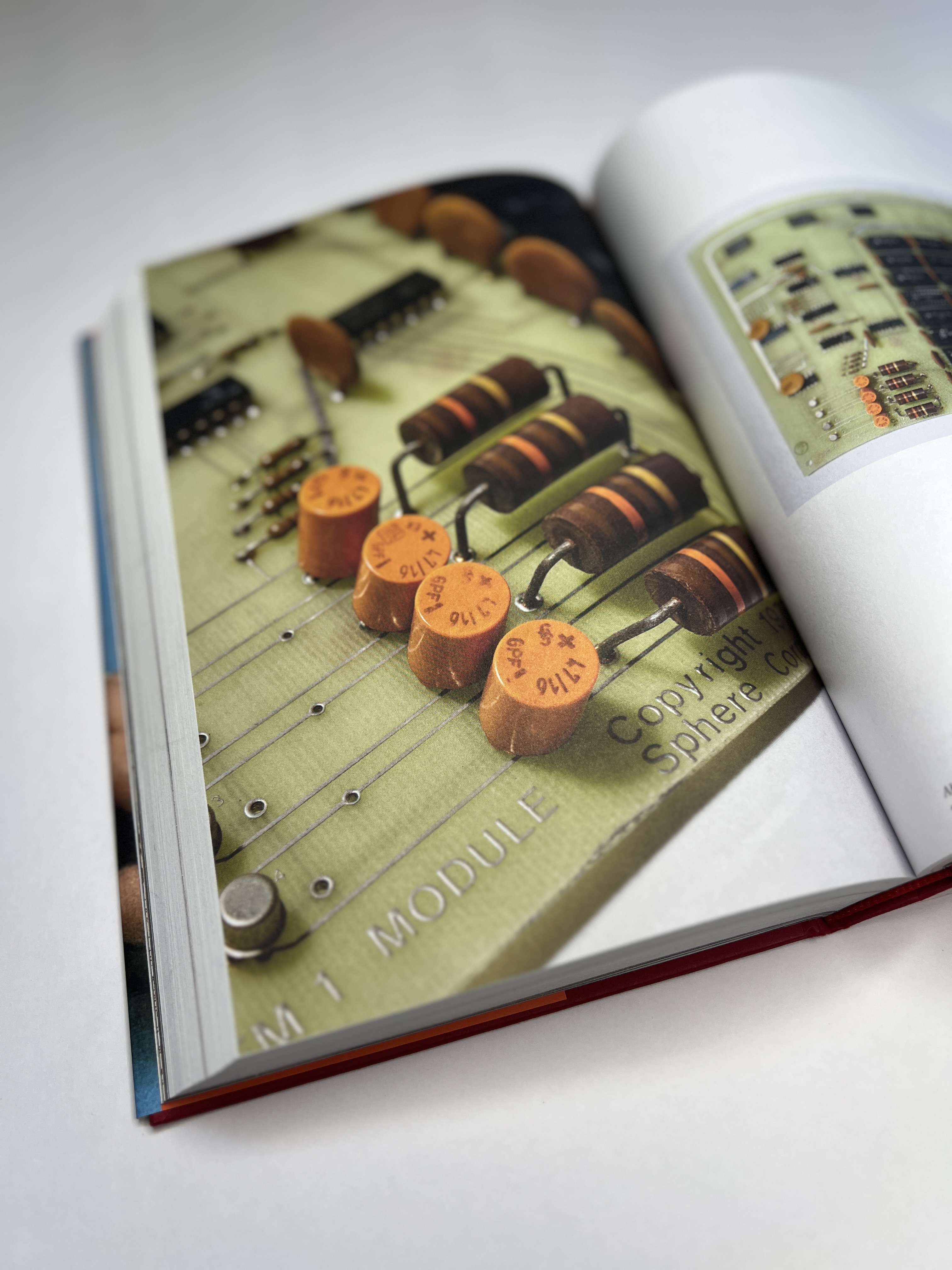 Close-up photograph of capacitors and resistors on a Sphere circuit board.